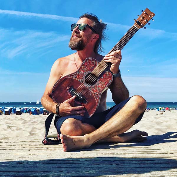 Travel Sings on the beach with santiago guitar